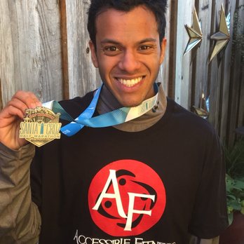 Client holding a Santa Cruz half marathon medal